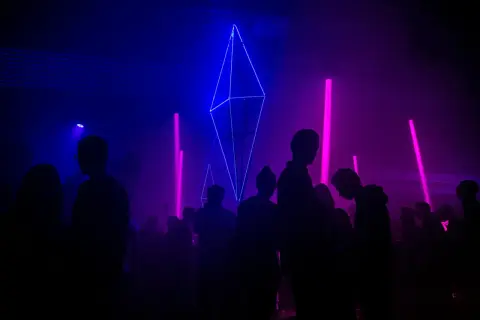 Tłumy bawią się przy neonowych światłach i geometrycznych instalacjach, tworząc atmosferę największych imprez techno na świecie.