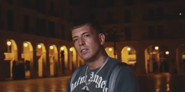 Sentino, znany z kontrowersyjnej **biografii**, w ciemnej scenerii miejskiej.